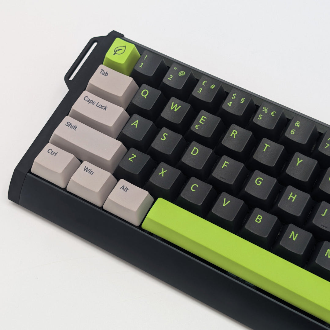 green, off white and black non-backlit keycaps on grey background.
