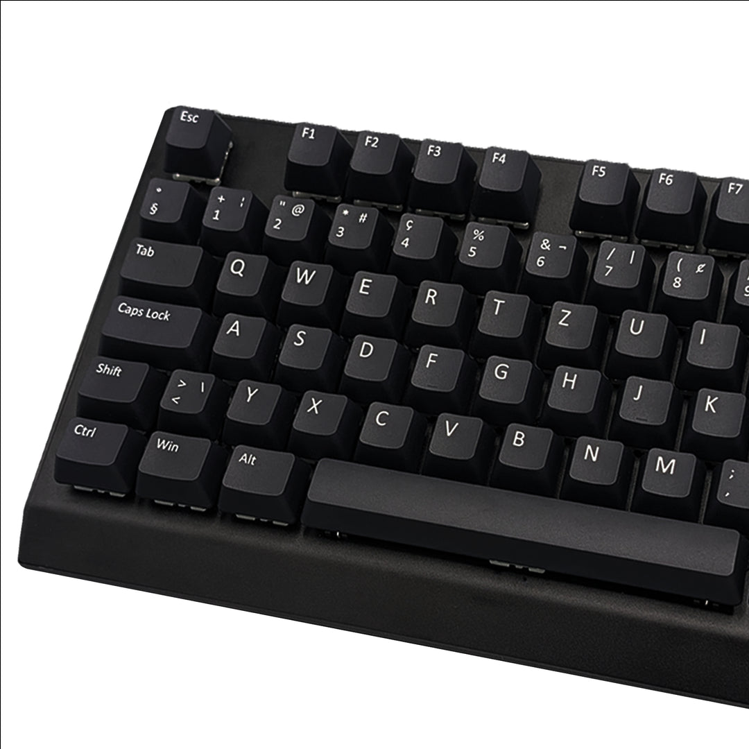 Close-up of black non-backlit PBT keycaps with dye-sublimated white legends, showing OEM profile shape and matte texture.