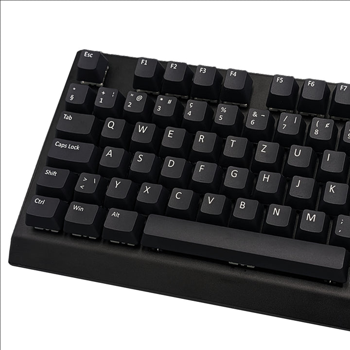 Close-up of black non-backlit PBT keycaps with dye-sublimated white legends, showing OEM profile shape and matte texture.