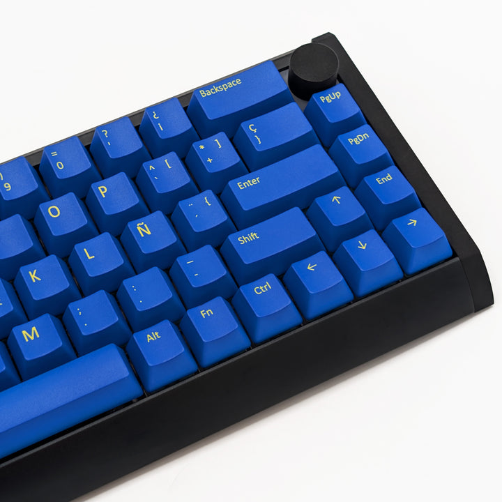 Mechanical keyboard fitted with customisable blue PBT keycaps, non-backlit QWERTY OEM profile with yellow legends and ANSI-compatible layout.
