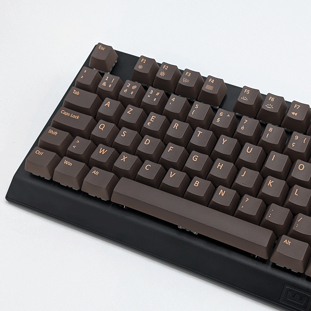 Close-up of brown AZERTY PBT keycaps on a mechanical keyboard, non-backlit OEM profile with clean light brown legends and matte texture.