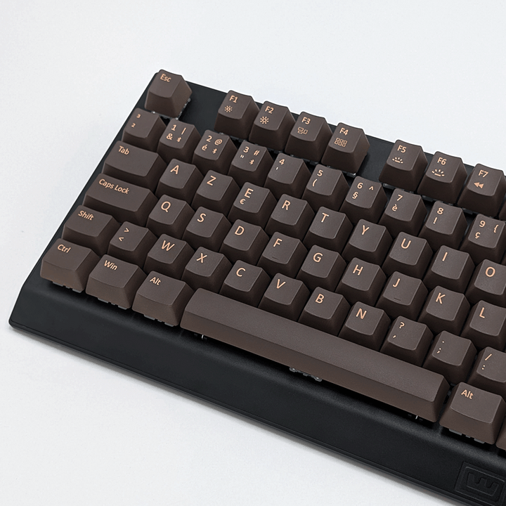 Close-up of brown AZERTY PBT keycaps on a mechanical keyboard, non-backlit OEM profile with clean light brown legends and matte texture.