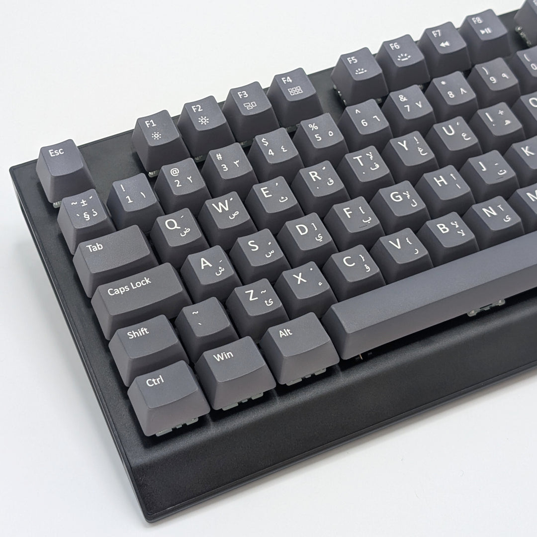 Mechanical keyboard fitted with customisable grey QWERTY PBT keycaps, non-backlit OEM profile with white legends and ISO-compatible layout.