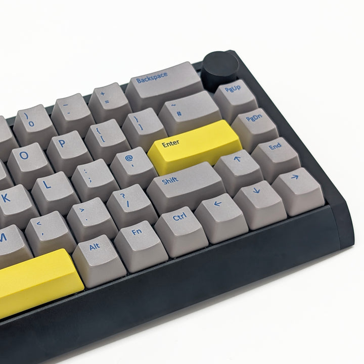 Mechanical keyboard fitted with customisable light grey QWERTY PBT keycaps, non-backlit OEM profile with blue legends and ANSI-compatible layout.