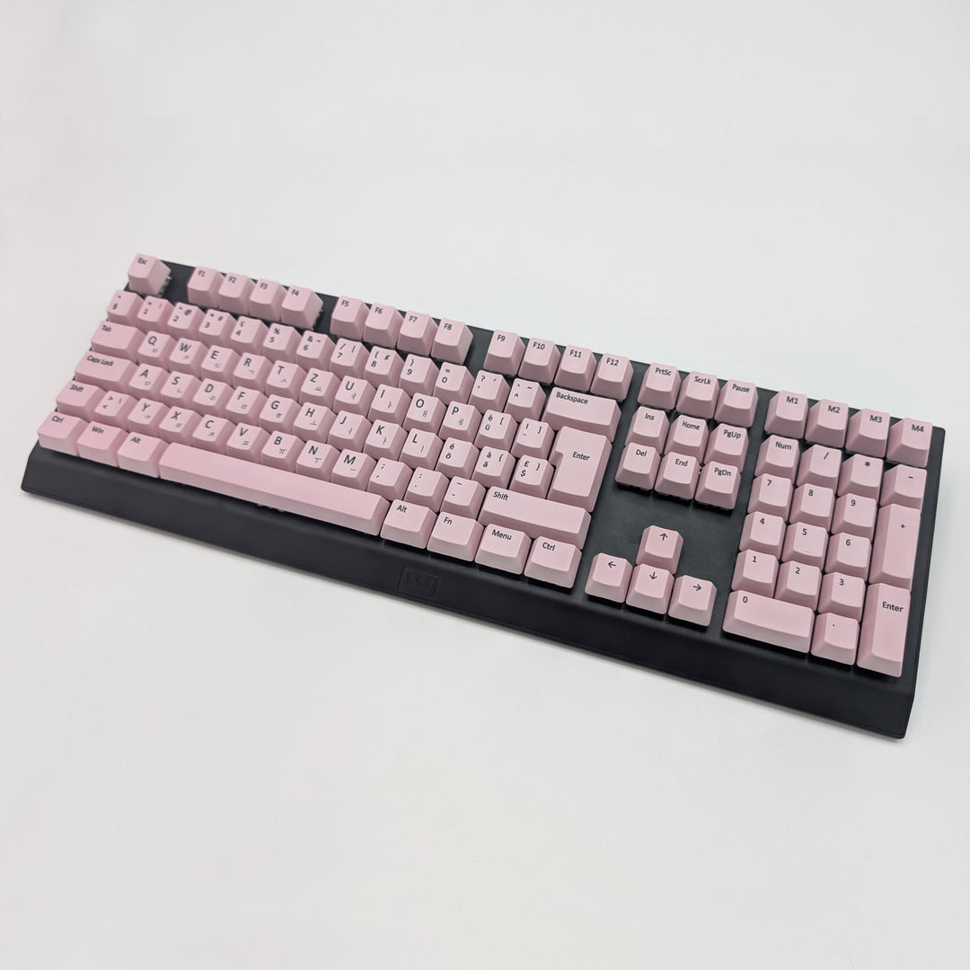 Light pink OEM profile QWERTZ PBT keycaps installed on a mechanical keyboard, showing non-backlit keys with dye-sublimated black legends.