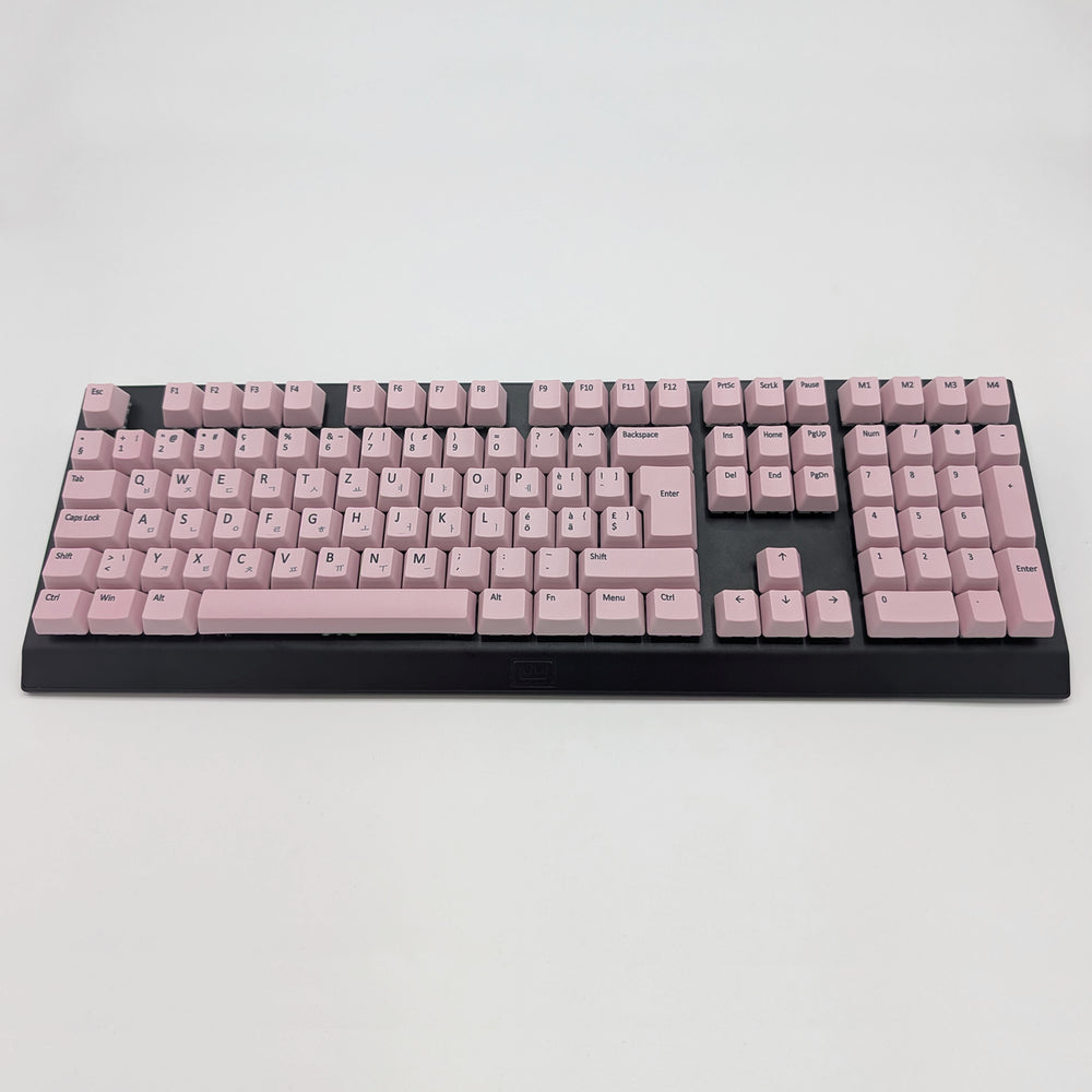 Customisable light pink non-backlit QWERTZ PBT keycaps with black legends on a mechanical keyboard, featuring OEM profile keys.