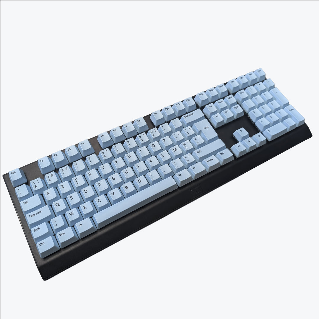 Light blue OEM profile AZERTY PBT keycaps installed on a mechanical keyboard, showing non-backlit keys with dye-sublimated black legends.