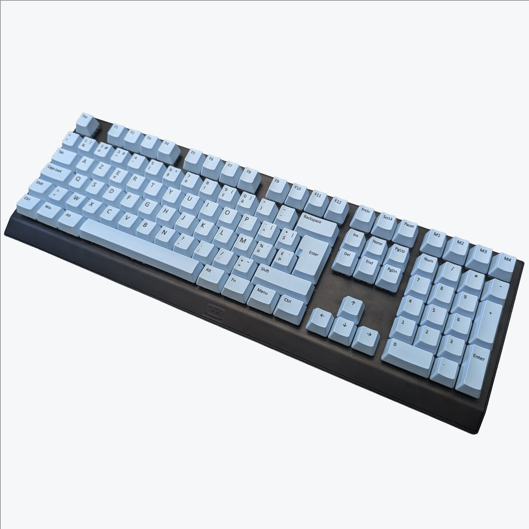 Light blue ISO-compatible OEM profile AZERTY PBT keycaps with matte finish installed on a mechanical keyboard, showing non-backlit keys with dye-sublimated black legends.