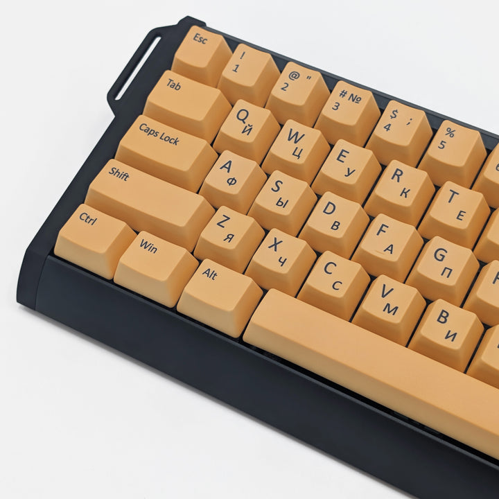 Close-up of Light Orange QWERTY PBT keycaps with black legends, non-backlit OEM profile keys with a matte finish on a mechanical keyboard.