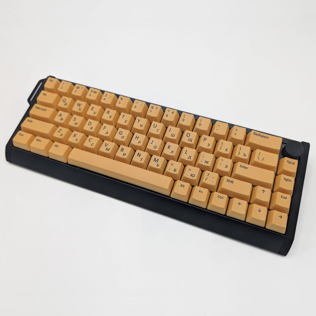 Light orange OEM profile QWERTY PBT keycaps installed on a mechanical keyboard, showing non-backlit keys with dye-sublimated black legends.