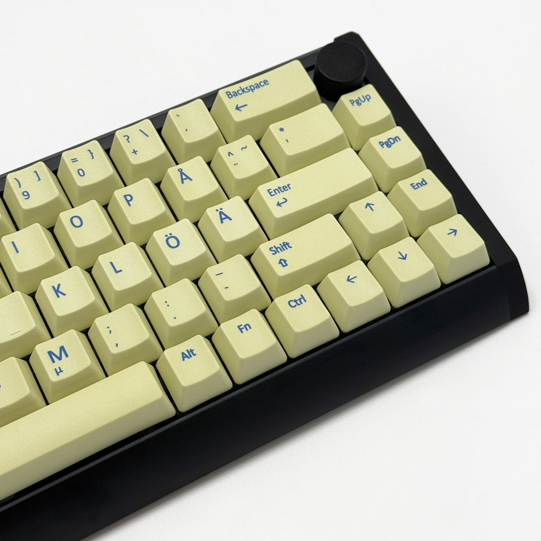 Mechanical keyboard fitted with customisable Light Yellow QWERTY PBT keycaps, non-backlit OEM profile with blue legends and ANSI-compatible layout.