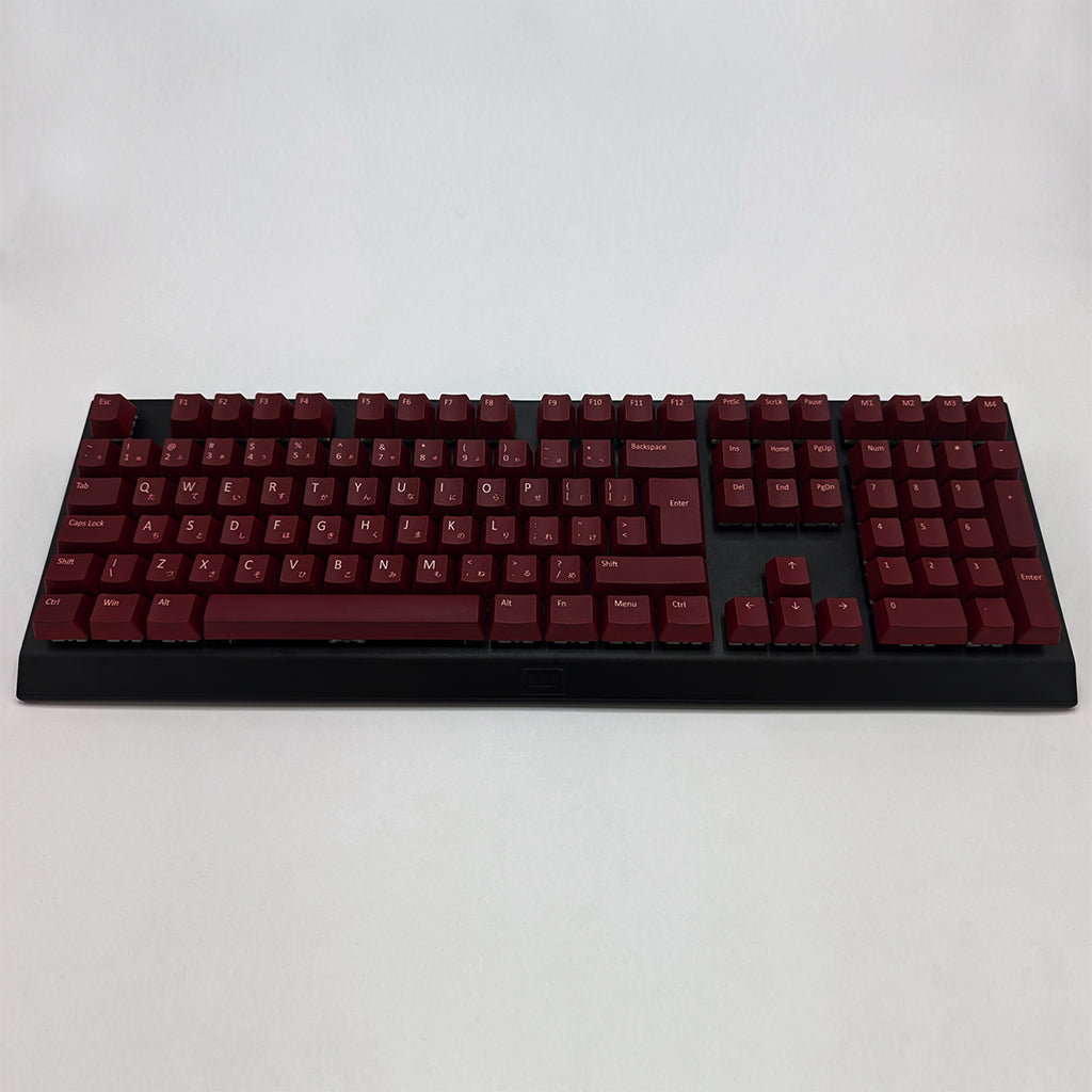 Customisable Maroon non-backlit QWERTY PBT keycaps with white legends on a mechanical keyboard, featuring ISO-compatible OEM profile keys with matte finish.