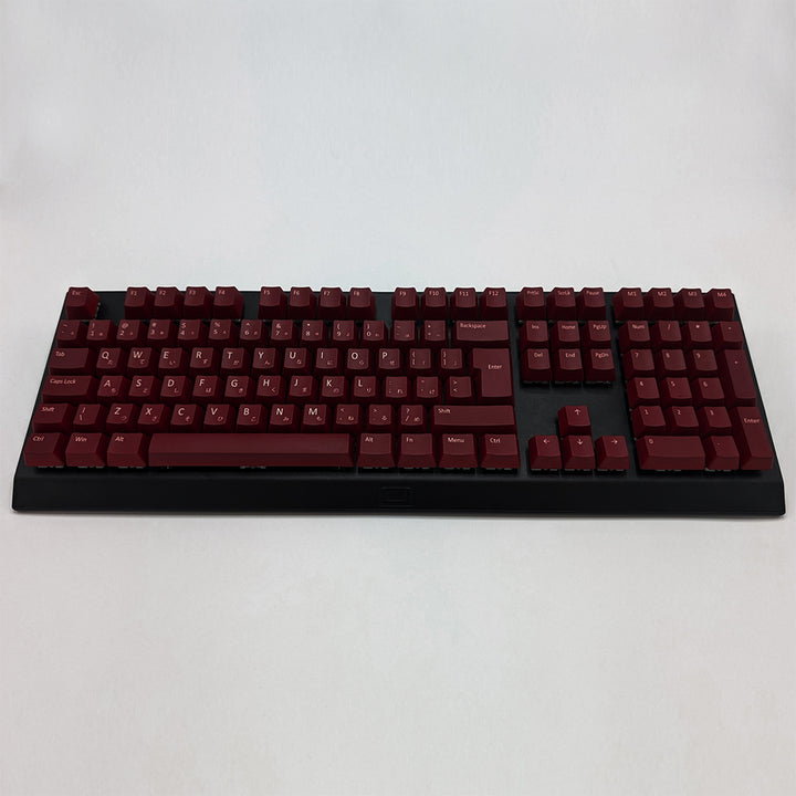 Customisable Maroon non-backlit QWERTY PBT keycaps with white legends on a mechanical keyboard, featuring ISO-compatible OEM profile keys with matte finish.