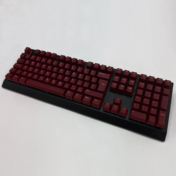 Maroon ISO-compatible OEM profile QWERTY PBT keycaps with matte finish installed on a mechanical keyboard, showing non-backlit keys with dye-sublimated white legends.