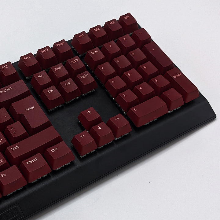Mechanical keyboard fitted with customisable Maroon QWERTY PBT keycaps, non-backlit ISO-compatible OEM profile with white legends and matte finish.
