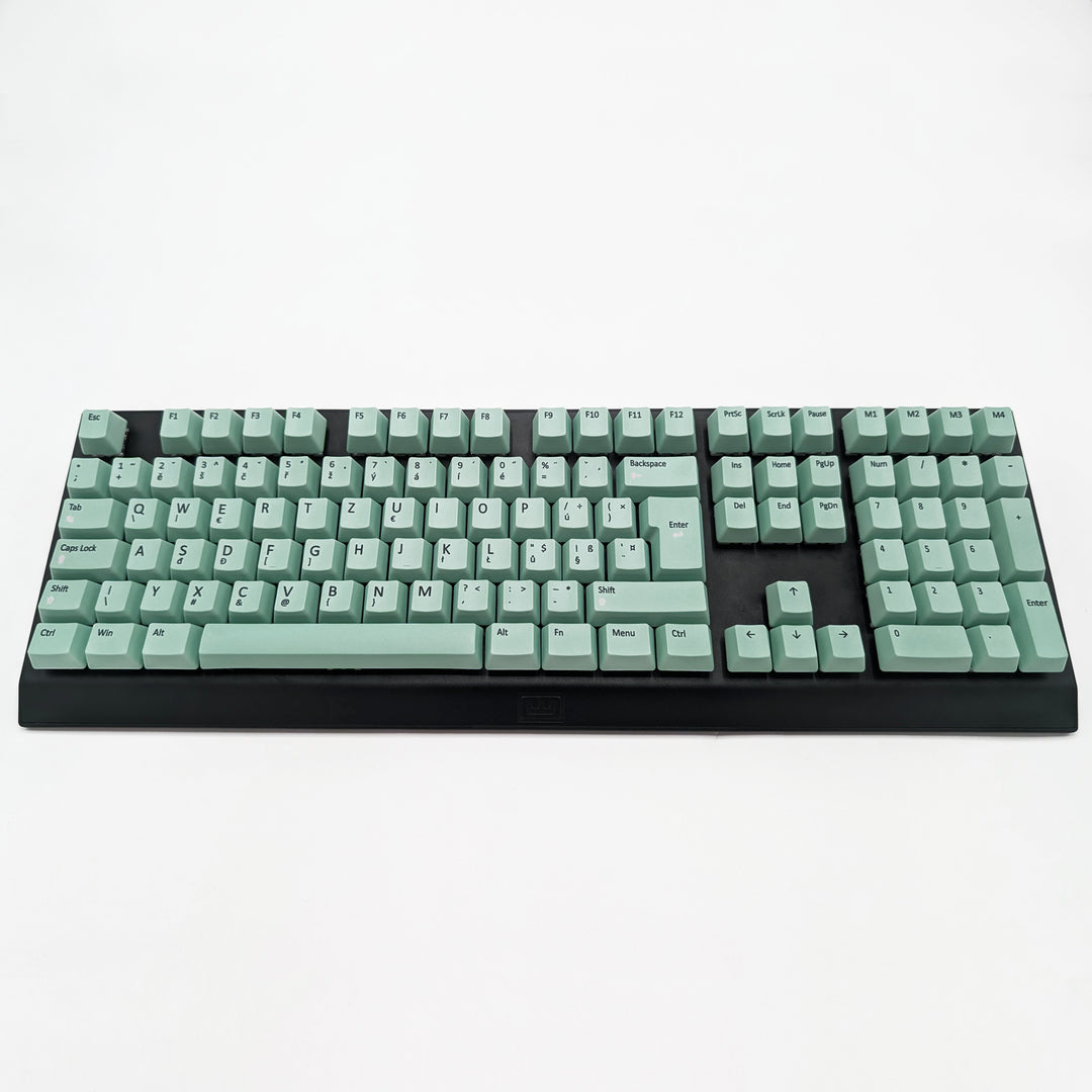 Customisable Mint non-backlit QWERTZ PBT keycaps with black legends on a mechanical keyboard, featuring ISO-compatible OEM profile keys with matte finish.