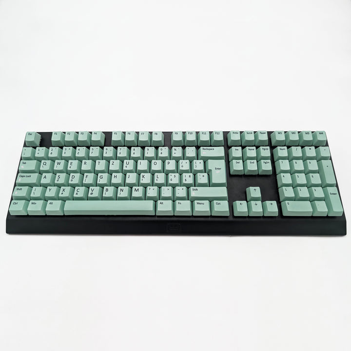 Customisable Mint non-backlit QWERTZ PBT keycaps with black legends on a mechanical keyboard, featuring ISO-compatible OEM profile keys with matte finish.