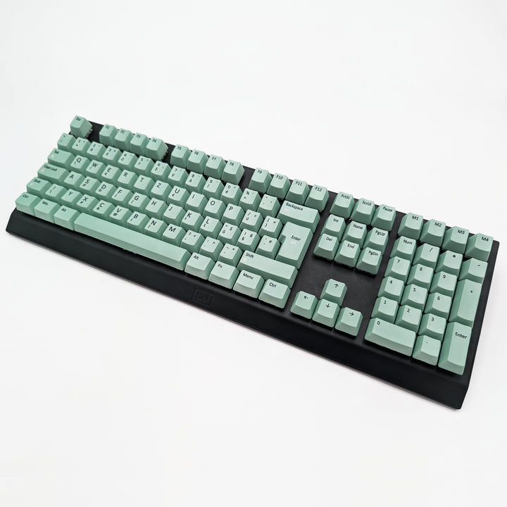 Mint ISO-compatible OEM profile QWERTZ PBT keycaps with matte finish installed on a mechanical keyboard, showing non-backlit keys with dye-sublimated black legends.