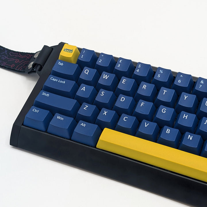 Close-up of Navy QWERTY PBT keycaps with white legends, non-backlit ANSI OEM profile keys with matte finish on a mechanical keyboard.