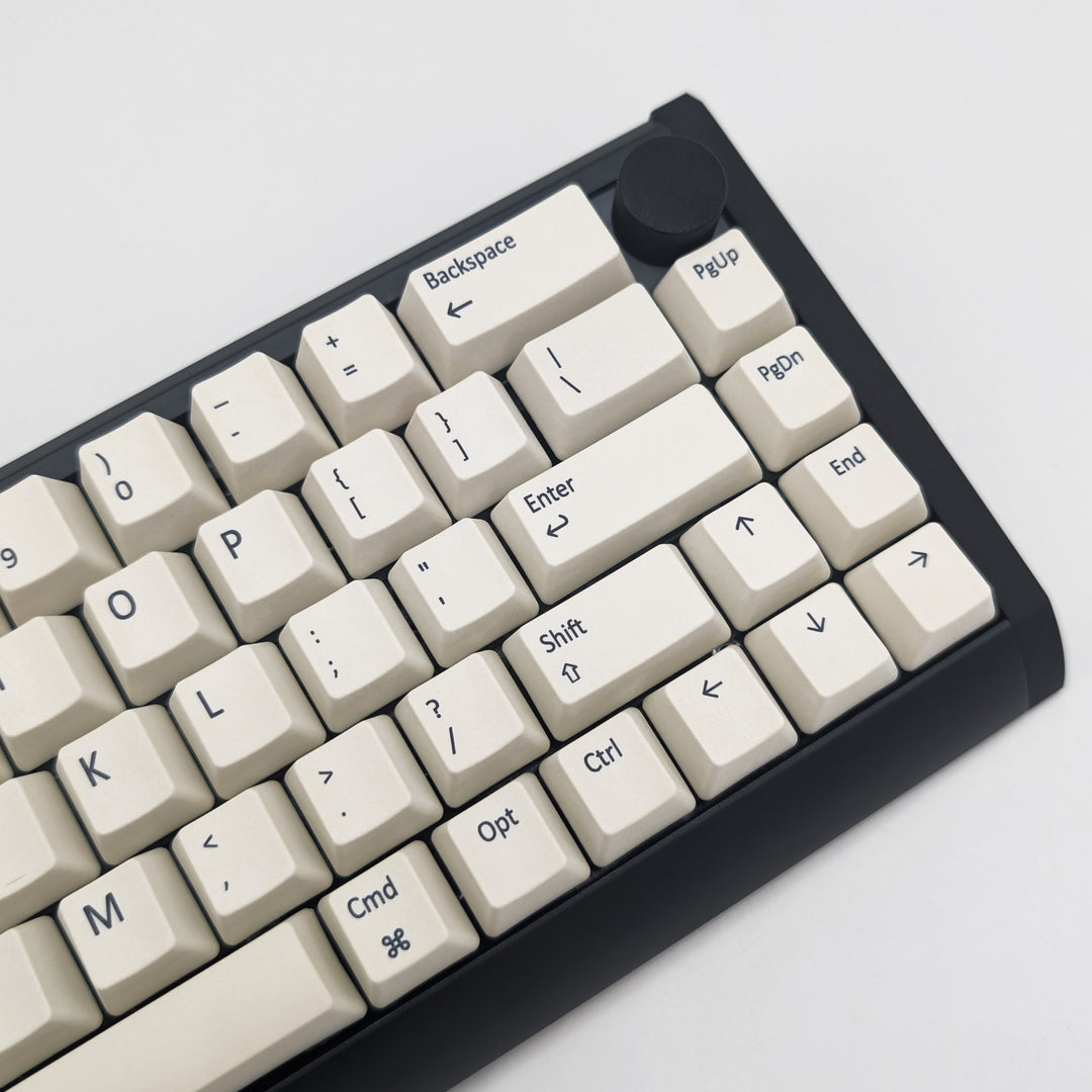 Side shot of Off White QWERTY PBT keycaps on a mechanical keyboard, featuring OEM profile keys with White, Cream, Beige and Off White Keycaps