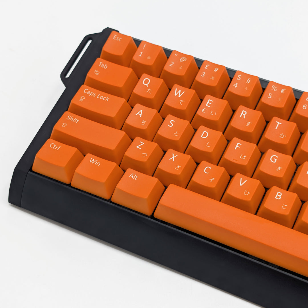 Close-up of Orange QWERTY PBT keycaps with white legends, non-backlit ANSI OEM profile keys with matte finish on a mechanical keyboard.