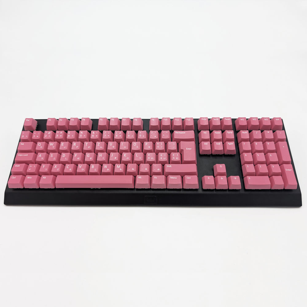 Customisable Pink non-backlit QWERTZ PBT keycaps with white legends on a mechanical keyboard, featuring ISO-compatible OEM profile keys with matte finish.