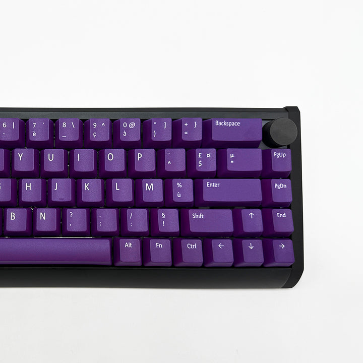 Close-up of purple PBT keycaps with white legends, non-backlit ANSI AZERTY OEM profile keys with matte finish on a mechanical keyboard.