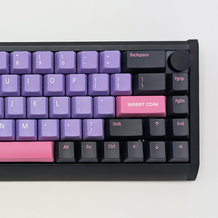 Close-up of RETRO QWERTY PBT keycaps on a mechanical keyboard, featuring OEM profile keys with Purple, Grey and Pink Keycaps