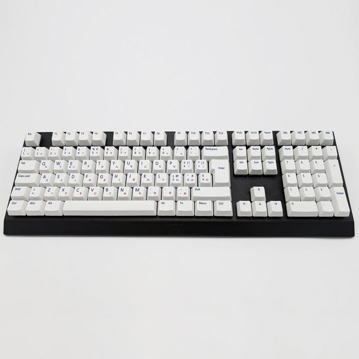 Customisable white non-backlit PBT keycaps with blue and red legends on a mechanical keyboard, featuring ISO-compatible QWERTY OEM profile keys with matte finish.