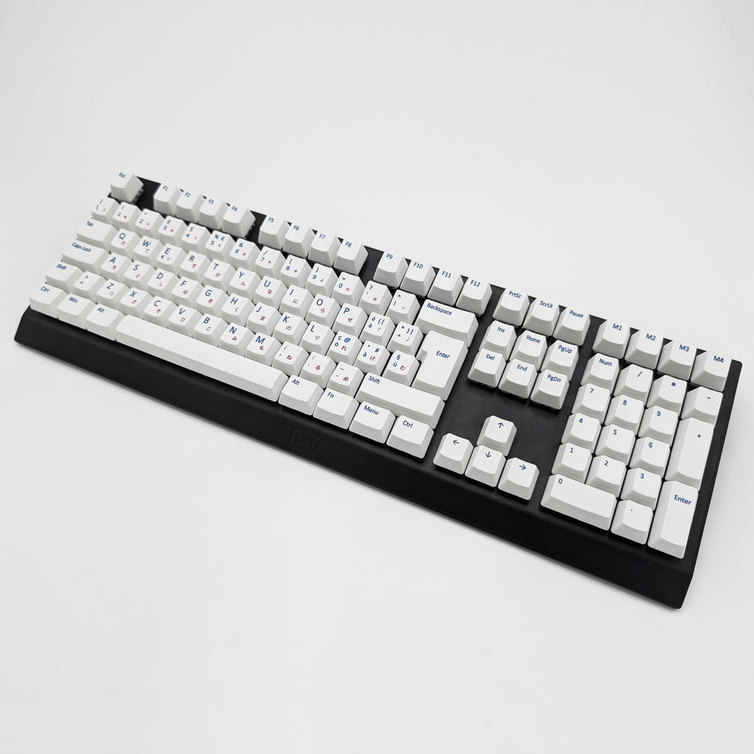 White ISO-compatible QWERTY OEM profile PBT keycaps with matte finish installed on a mechanical keyboard, showing non-backlit keys with dye-sublimated blue and red legends.