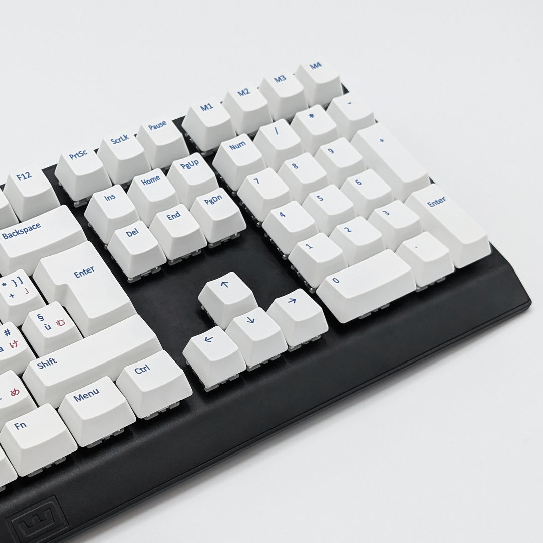 Mechanical keyboard fitted with customisable white PBT keycaps, non-backlit ISO-compatible QWERTY OEM profile with blue and red legends and matte finish.
