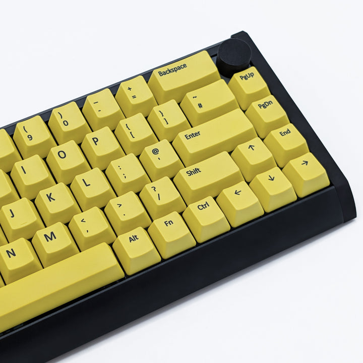 Close-up of Customisable Yellow non-backlit QWERTY PBT keycaps with black legends on a mechanical keyboard, featuring OEM profile keys.