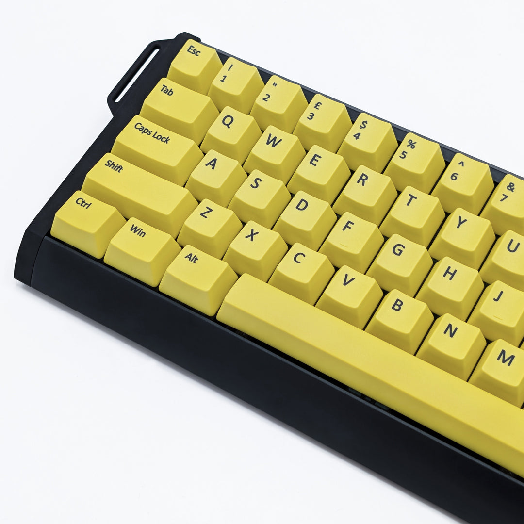 Close-up of Customisable Yellow non-backlit QWERTY PBT keycaps with black legends on a mechanical keyboard, featuring OEM profile keys.